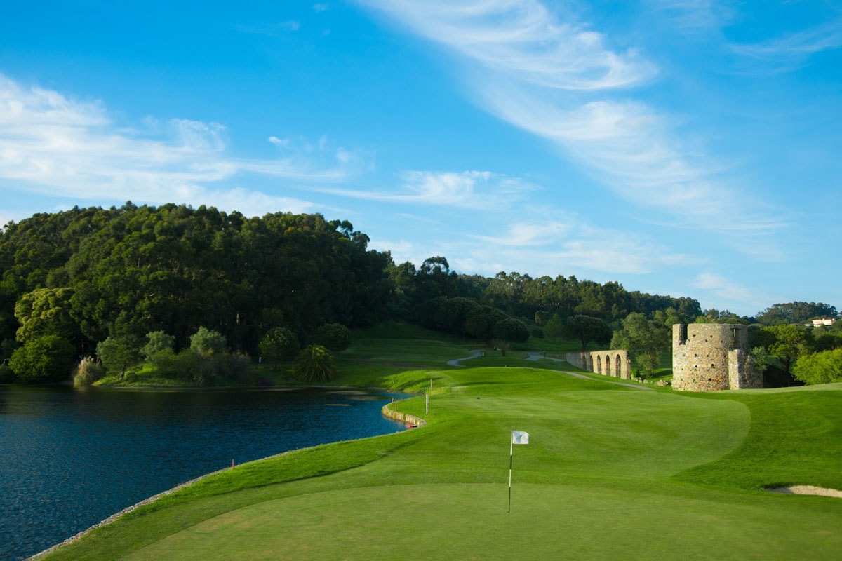 A golfer teeing off on a sunny day, illustrating the ideal weather for golf holidays in Portugal.