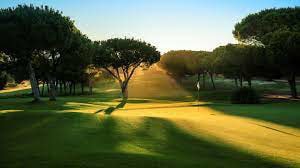 A scenic view of a golf course in Portugal, showcasing the lush greens and blue skies, perfect for short golf breaks.